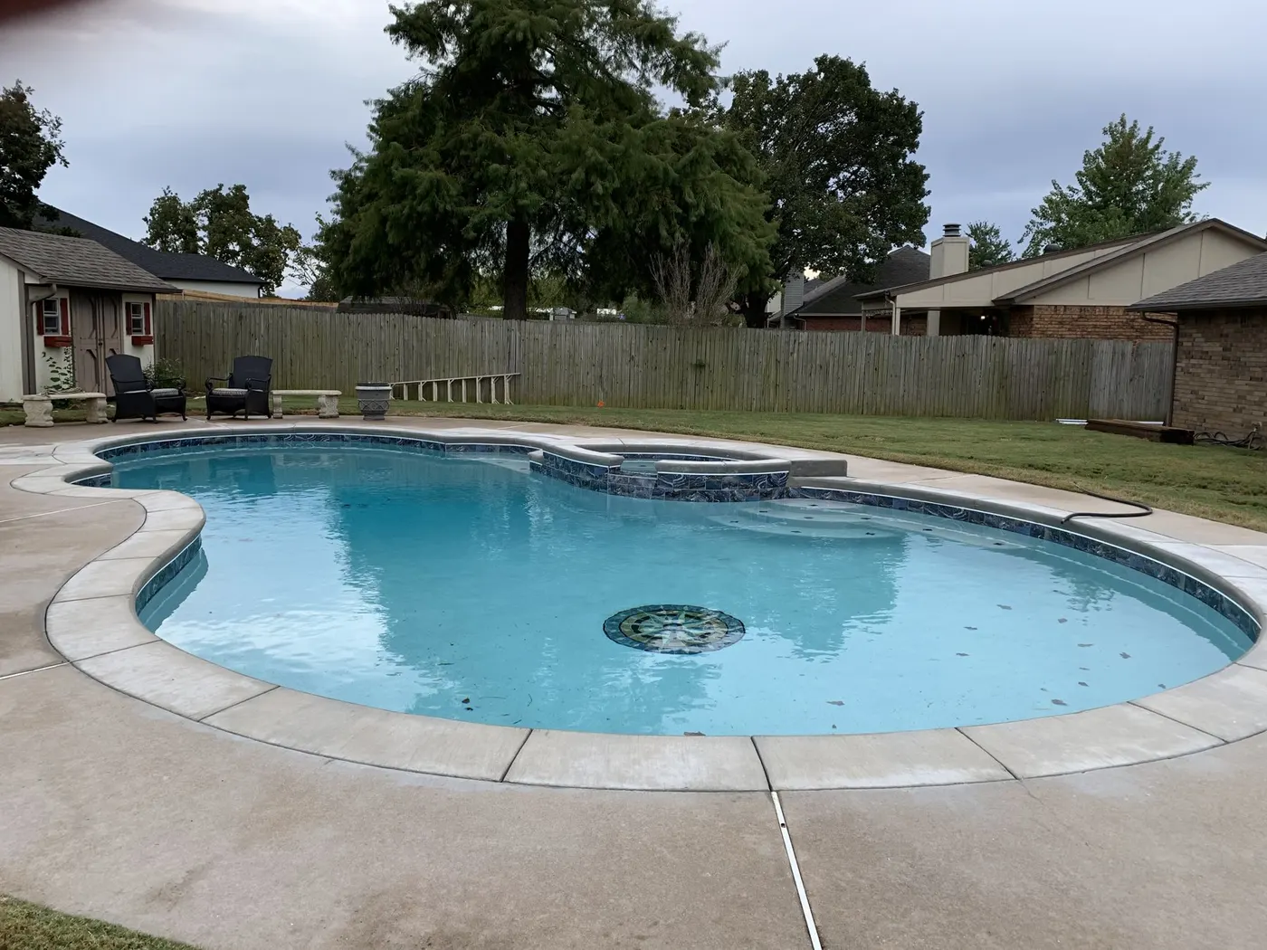 Same pool and spa refilled after resurfacing, with bright new finish