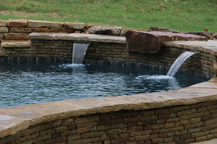 Complete view of dual-basin pool design with main pool and attached spa feature