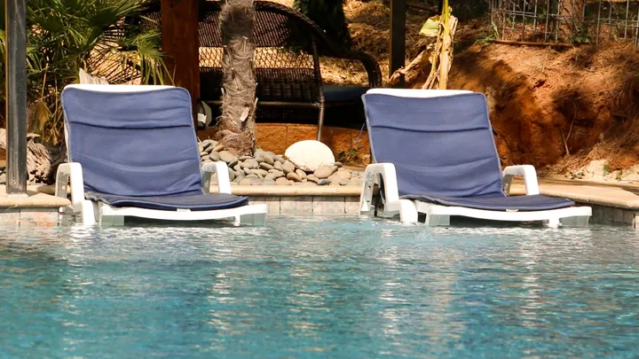 Slightly different angle showing pool with deck and railing view