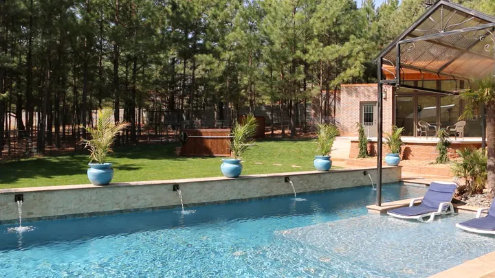 Alternative angle showing pool from left side with full landscape and patio context