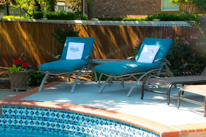 3D rendering of freeform pool with spa, landscaping, and poolside cabana