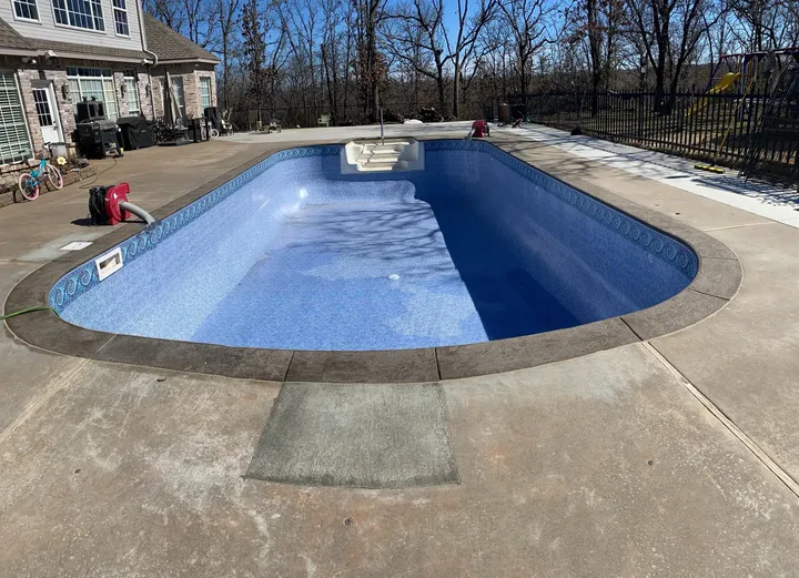 Pool refilled with a new blue vinyl liner after renovation