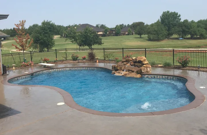 Finished pool with metal rock waterfall feature and metal deck edging