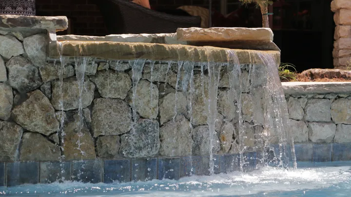 Multi-level stone waterfall with dramatic water cascade