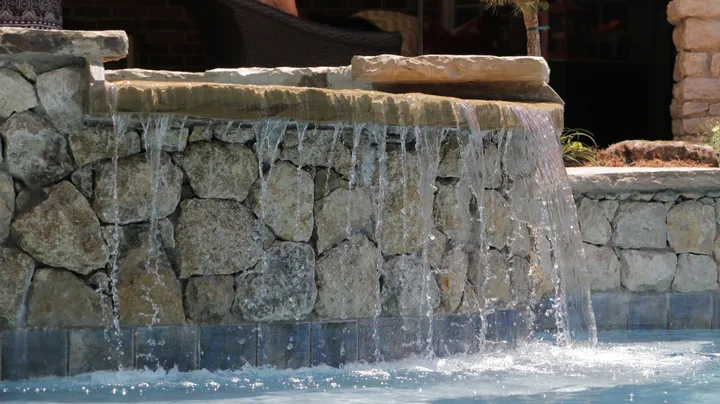 Large stone waterfall construction with professional design detail