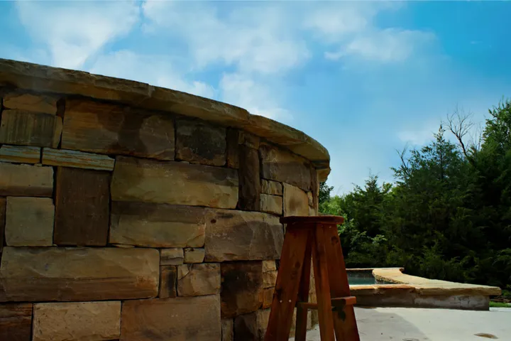 Pool with natural stone waterfall and balance beam feature